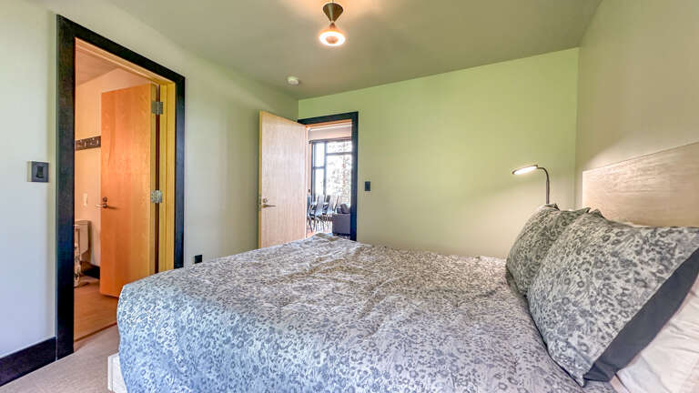 This bedroom has a queen bed and attached bathroom.