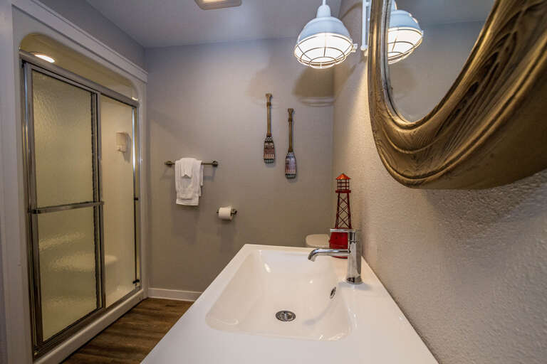 The bathroom offers a double sink and a walk-in shower
