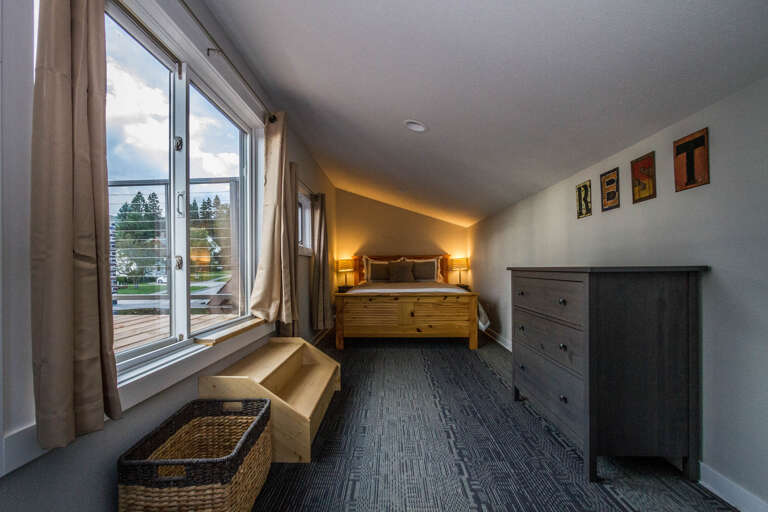 The bedroom is locate don the upper level of the apartment.