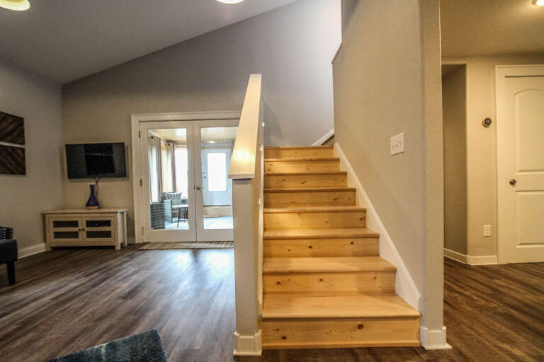 Two sets of stairs leads you to the upper level guest bedroom.