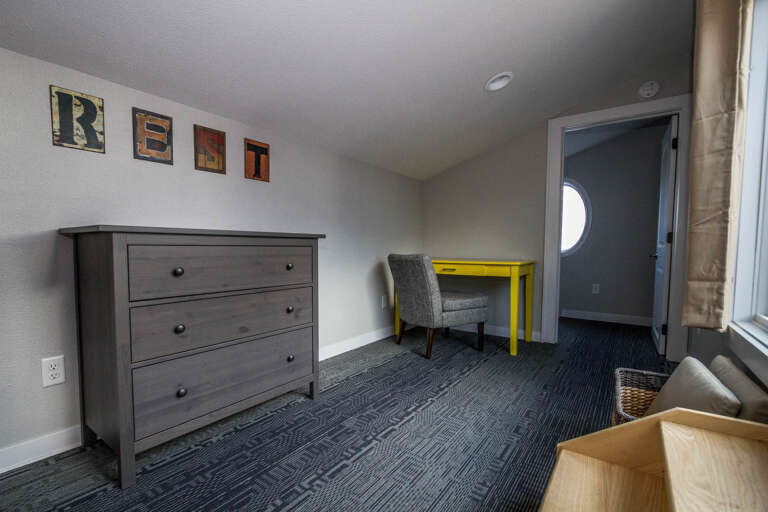 This spacious guest bedroom features a queen bed