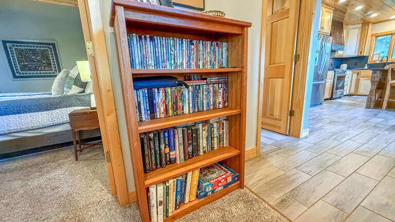 Curl up with a favorite book or movie from the well-stocked library, positioned between your bedroom and the spacious kitchenâperfect for cozy evenings in.