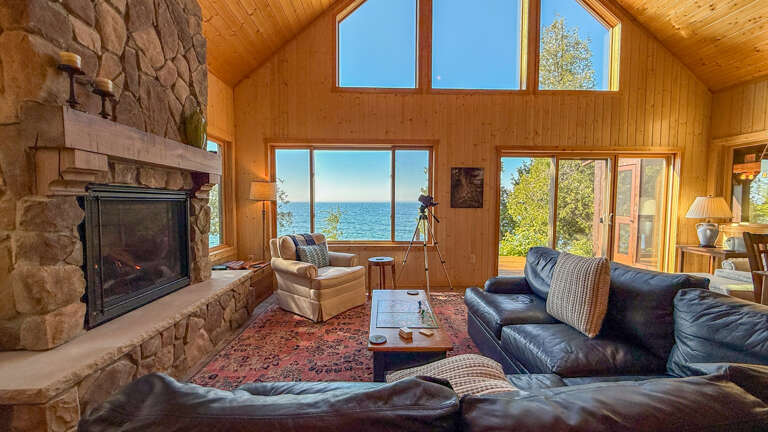 Sink into plush leather seating while your private fireplace glows and sparkling water views stretch endlessly before you through floor-to-ceiling windows.