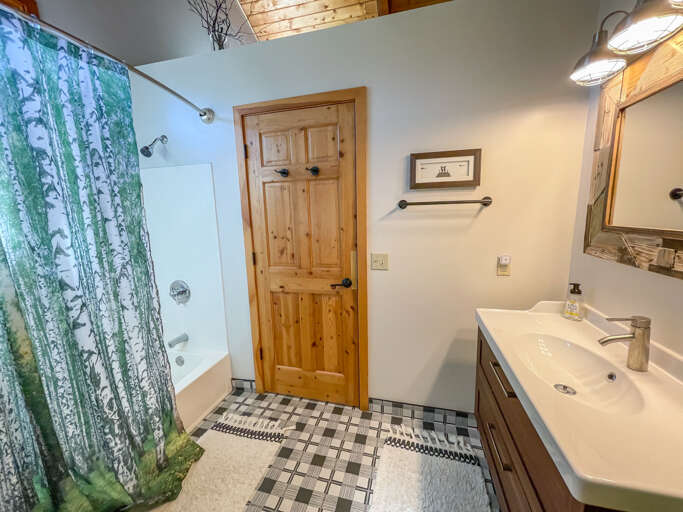 It offers a large vanity and a shower/tub combo