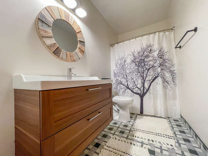 This guest bedroom is located on the lower level and it offers a shower/tub combo.