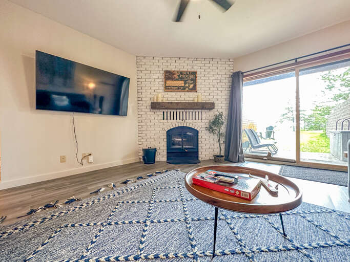 Large screen TV and a wood burning fireplace round out the lower level living room.