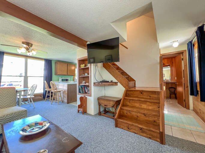 New smart TV and the staircase to the upper level.