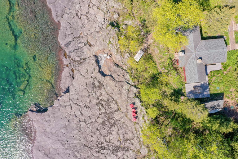 Aerial view of the home and shoreline.