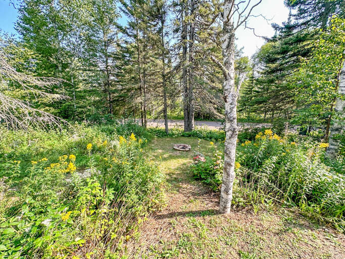 The home features a small yard with a fire pit.
