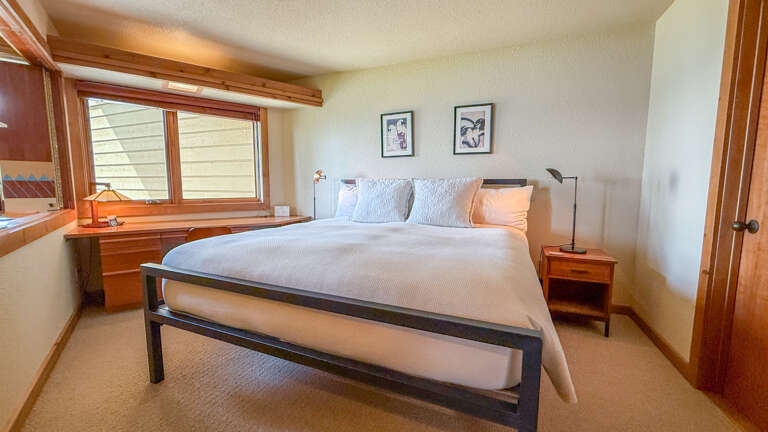 Bedroom with king bed and a workspace/office area.