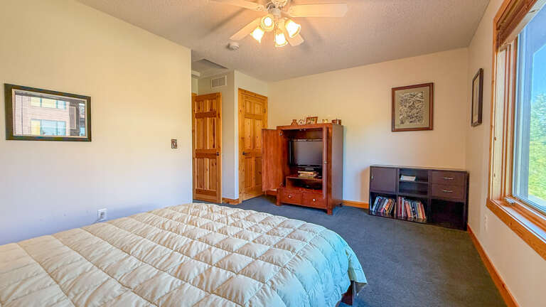 This bedroom has a TV and books to keep you entertained.