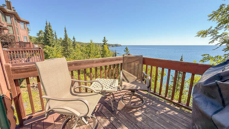 Step out onto the lake-facing deck from the living area.
