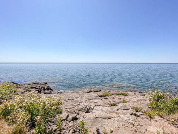 Lutsen House has Lake Superior to the front and a creek running to the west.