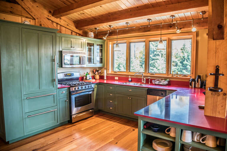 The kitchen features modern, stainless-steel appliances and custom cabinetry.
