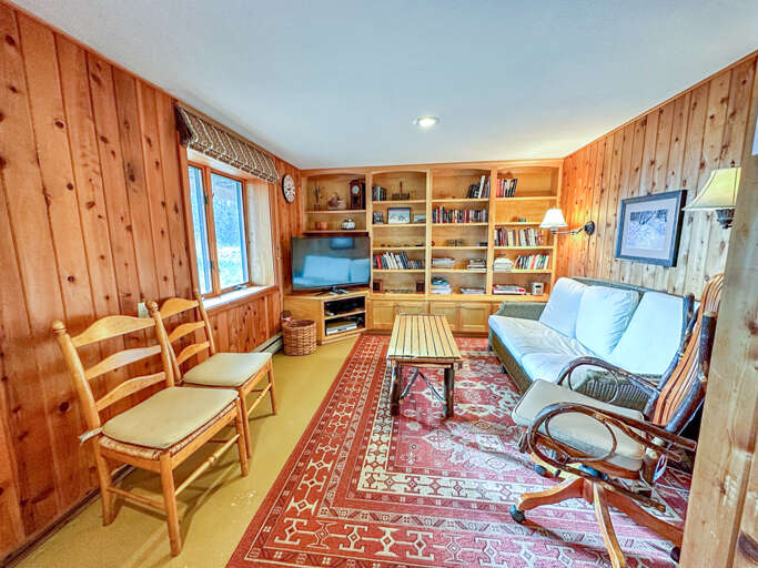 This room has a TV and a selection of books to enjoy.