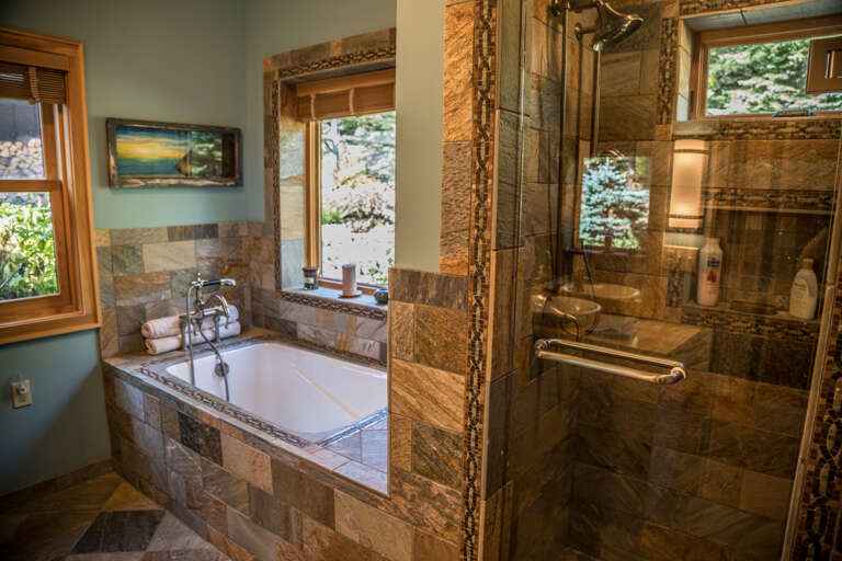 The attached bathroom has a soaker tub and a walk-in shower