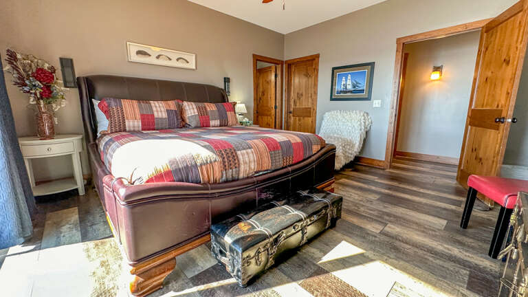 This bedroom has a king bed and attached bathroom.