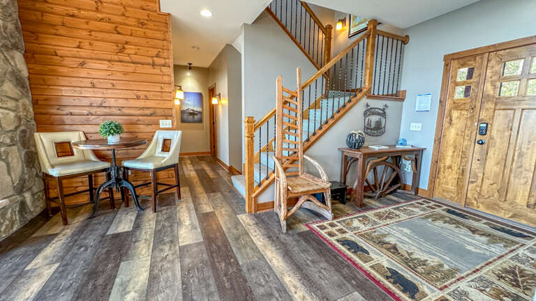 Entryway, staircases to the upper and lower levels, and the primary bedroom hallway.