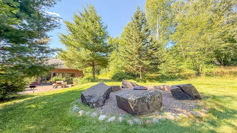 Fire pit and picnic/BBQ areas behind the pool and sauna building (shared, seasonal).