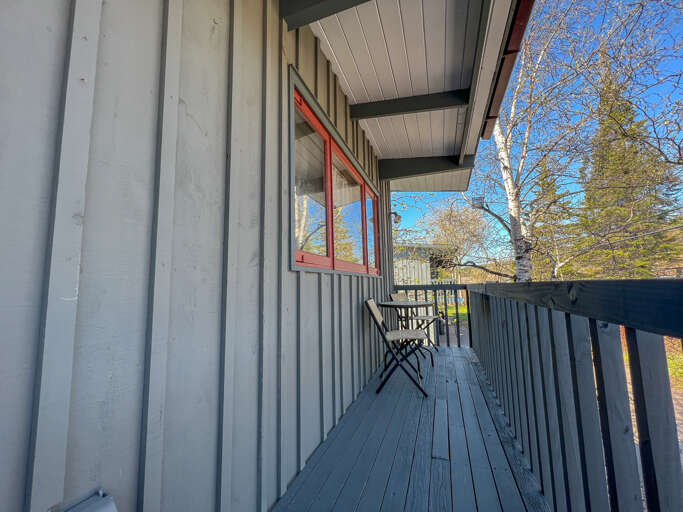 There is a hillside facing balcony off of the kitchen.