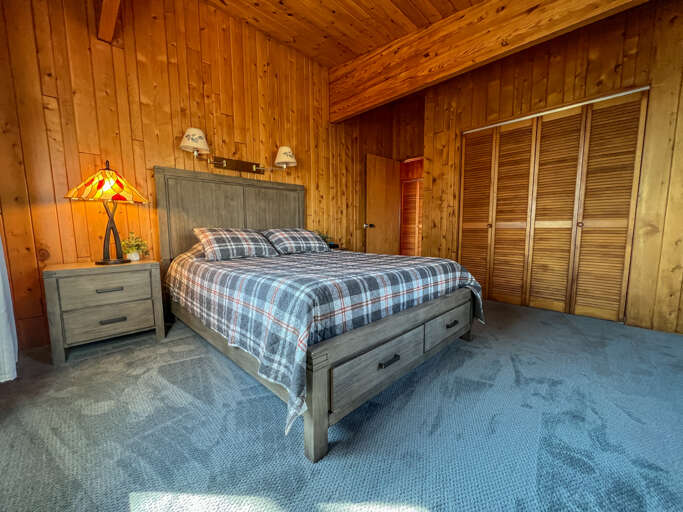 It features a queen sized bed with overhead light perfect for late night reading.