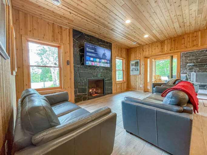 A 65" Smart TV is ready for watching a movie on a rainy day in the living room