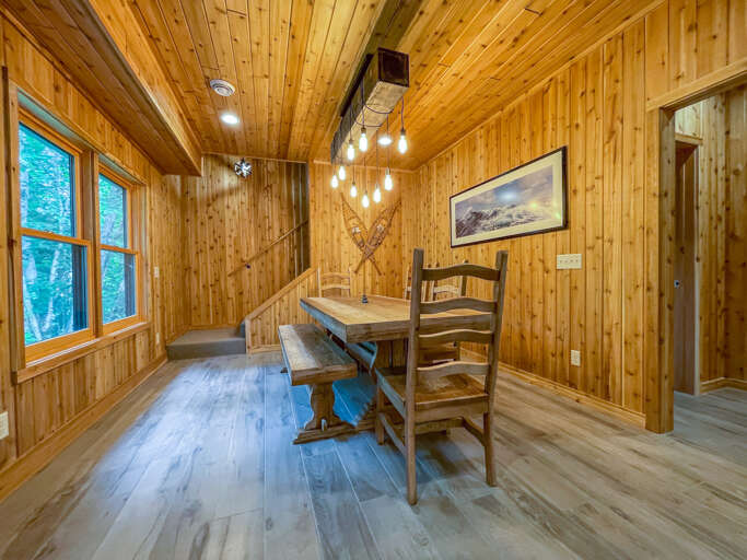 The dining room features a solid wood dining table.