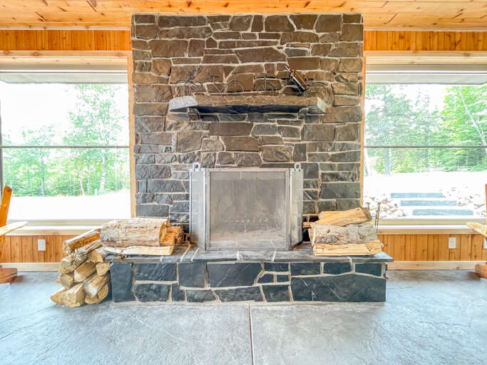Start up a fire in the stone-surround wood-burning fireplace.