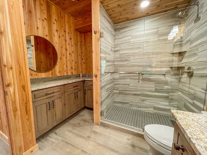 It features a walking shower with a high shower head.