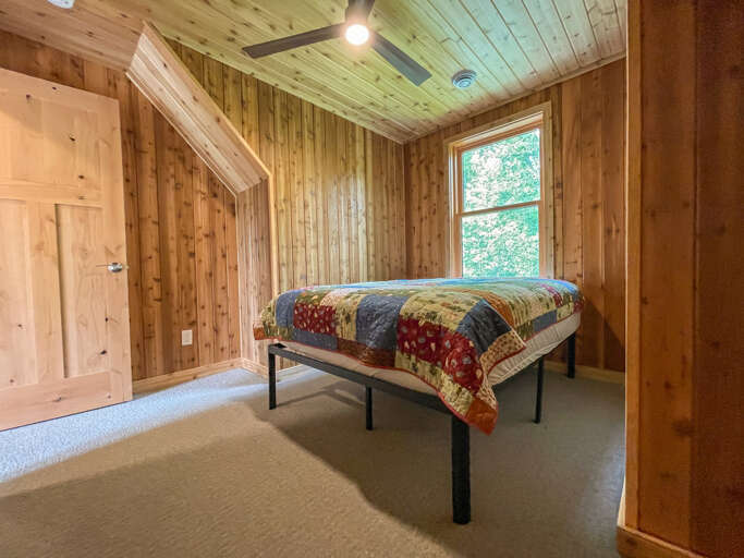 Guest bedroom 2 is located on the upper level and features a full bed