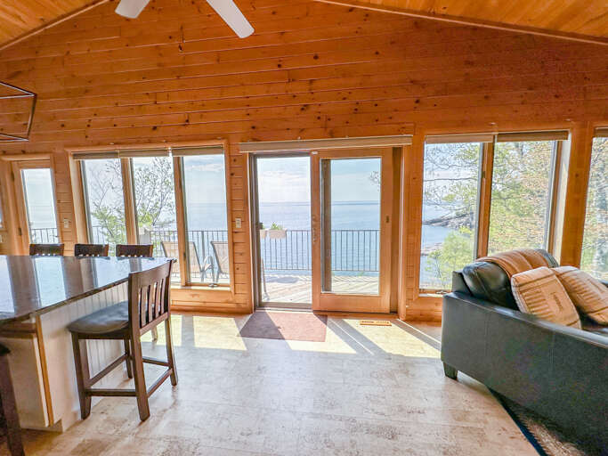 The lake-facing windows provide amazing views from both the living room and kitchen.