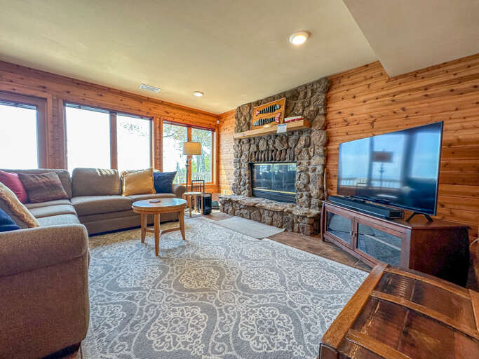 This living room features a stone surround fireplace and Smart TV.