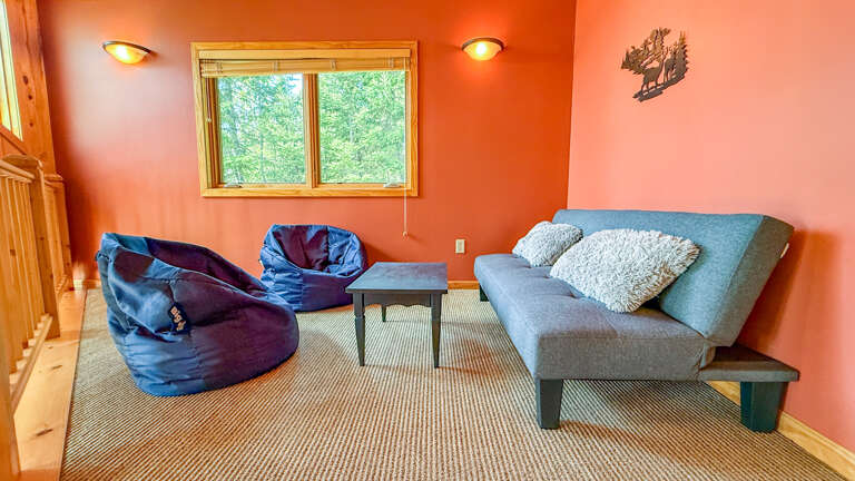 Sink into comfy seating and enjoy peaceful forest views from your cozy, warmly lit loungeâyour perfect spot to unwind after exploring.