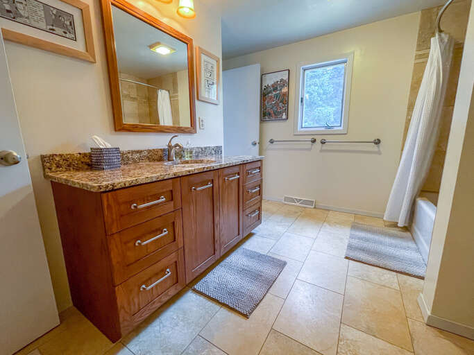 The bathroom features a large vanity.
