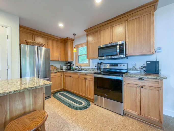 The kitchen has granite countertops and stainless appliances.