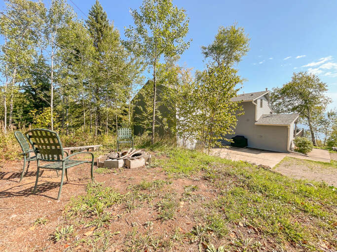 Enjoy a summertime fire in the firepit. There's also a gas grill located behind the home for a summertime BBQ.