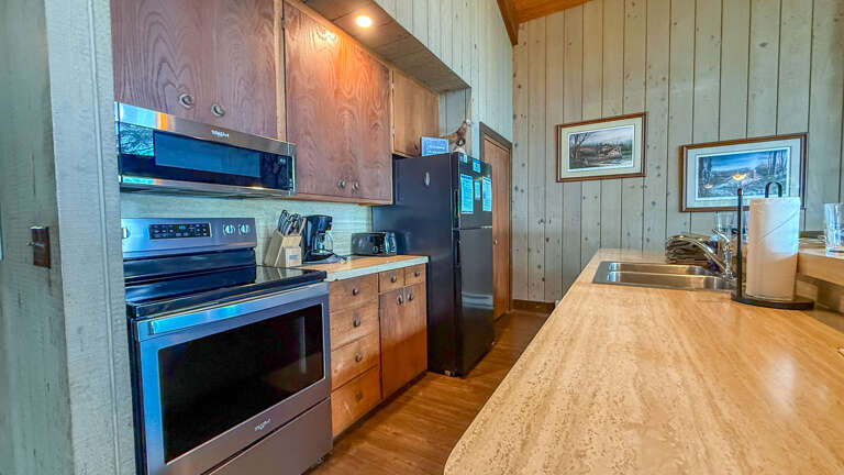 Your fully equipped kitchen features stainless steel appliances, warm wood cabinetry, and a spacious countertopâperfect for whipping up meals together during your stay.