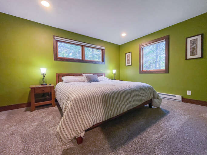 Guest bedroom one features a king bed