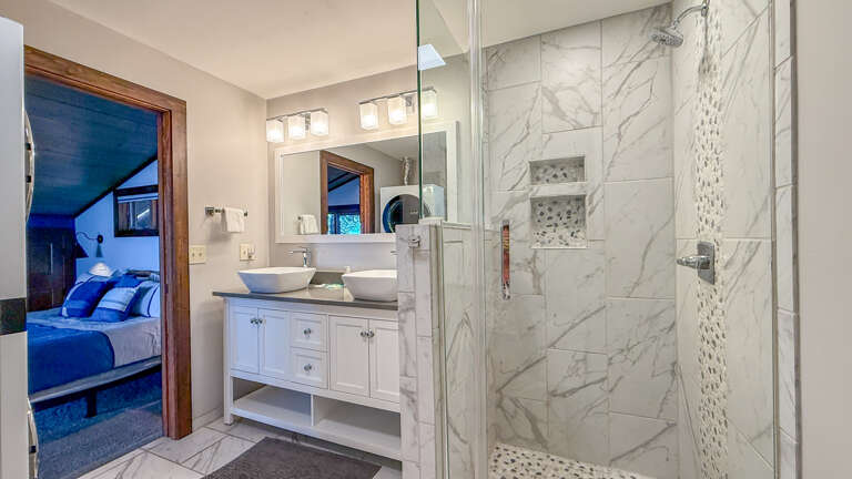 Refresh in your elegant ensuite with a spacious walk-in shower and stylish dual vanity, just steps from your cozy bedroom.