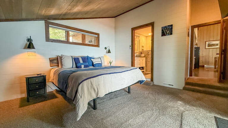 Sink into a cozy bed under warm lighting, with your private bathroom just steps away and calming natural light streaming through above.