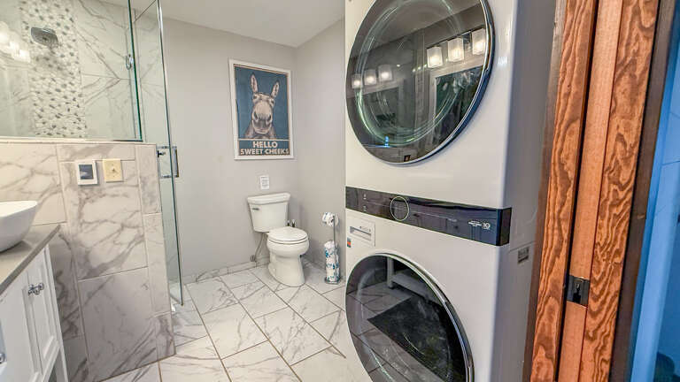 This all-in-one space offers everything you needâa sleek bathroom with a walk-in shower and a convenient stacked washer-dryer to keep your vacation wardrobe fresh.