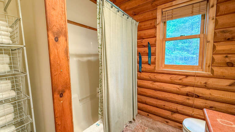 The bathroom has a shower/tub combo. The bathroom has a shower/tub combo.