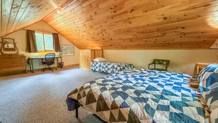 Loft bedroom with desk/work area.