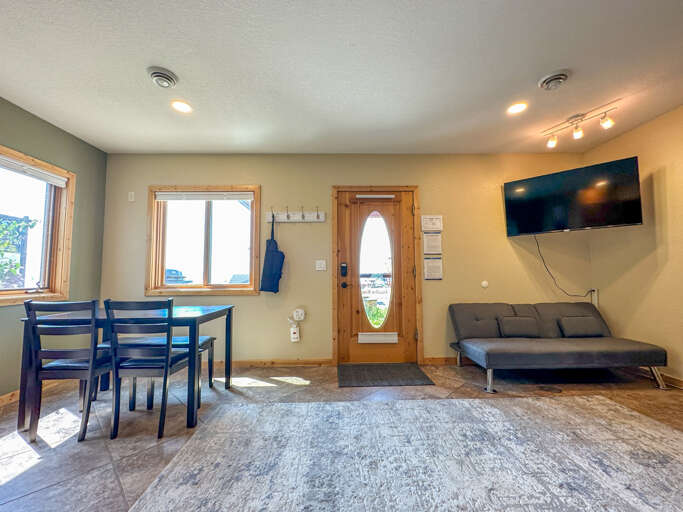 Dining area, entryway, and TV.
