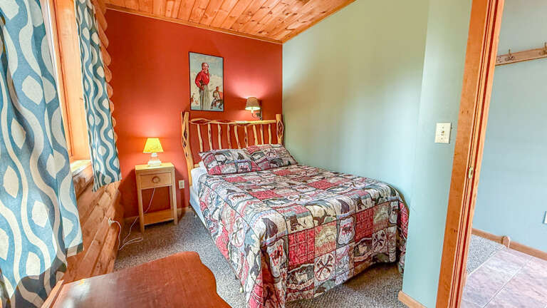 Your cozy bedroom welcomes with warm wooden accents and cheerful colors that create the perfect retreat for restful nights.