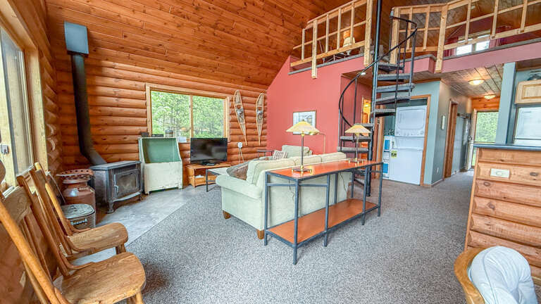 Your cozy log cabin retreat features rustic charm with a spiral staircase to your loft, wood-burning fireplace, and open-plan living perfect for relaxation.