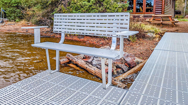 Relax on your private waterfront dock with comfortable seating, where gentle waves lap beneath your feet.