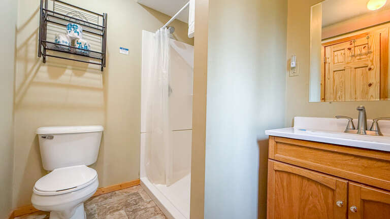 Your private bathroom features a spacious shower, comfortable vanity, and warm wood accents for a relaxing retreat.