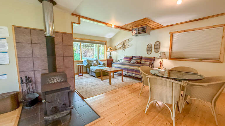 Cozy up in your charming loft retreat with warm wood floors, crackling fireplace, and comfortable seating perfect for relaxing evenings.