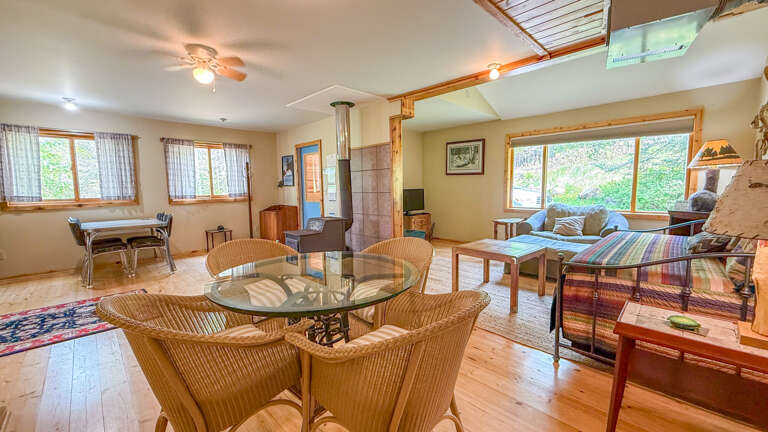 Unwind in this inviting open-concept living space where warm wood tones and natural light create the perfect atmosphere for your retreat.